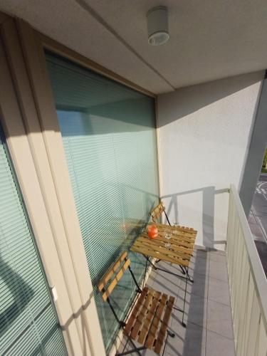 a balcony with a bench and a glass window at New air-conditioned apartment 5 minutes by walk from the airport with free garage parking in Bratislava