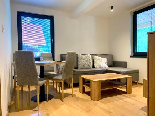 a living room with a couch and a table at Chata Horskej služby Trangoška - Chopok juh in Horná Lehota