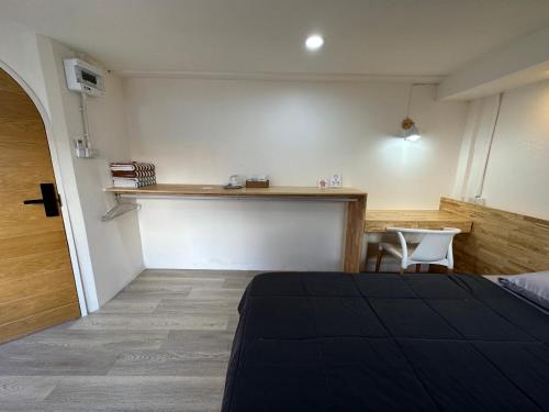 a bedroom with a bed and a table and a counter at Letter Better Home in Bangkok