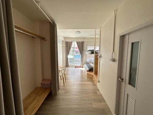 a hallway with a door leading to a room at Letter Better Home in Bangkok