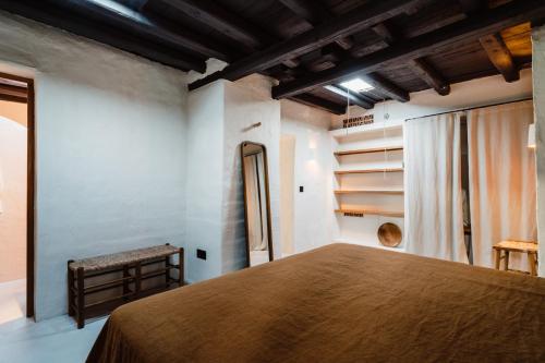 a bedroom with a large bed in a room at Aguamadera in Santa Eularia des Riu