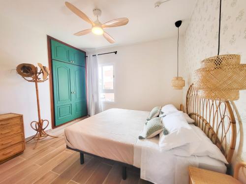 a bedroom with a bed and a green door at NEWQUAY in Playa de las Americas