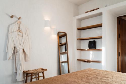 a dressing room with a robe hanging on a wall at Aguamadera in Santa Eularia des Riu