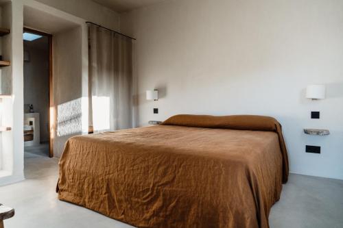 a bedroom with a bed with a brown blanket at Aguamadera in Santa Eularia des Riu
