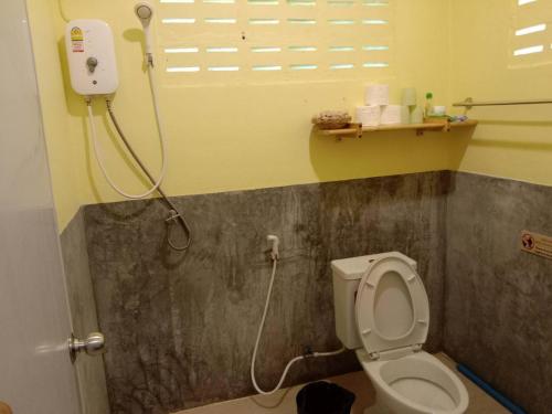 a bathroom with a toilet and a shower in it at The Best Bungalow in Ban Bang Chak