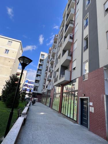 an empty sidewalk in front of a building at Sunrise Tirana Apartament's in Tirana