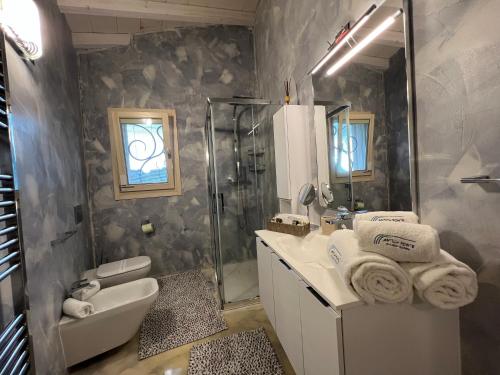 a bathroom with a sink toilet and a shower at Antica Fonte Holiday Homes in San Pantaleo