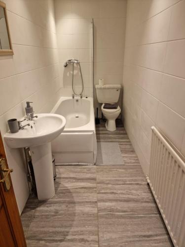a bathroom with a sink and a tub and a toilet at Luna Apartments Newcastle Gateshead 3 in Gateshead