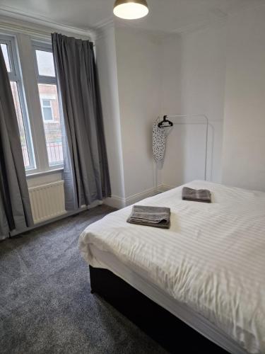 a bedroom with a bed and a large window at Luna Apartments Newcastle Gateshead 3 in Gateshead