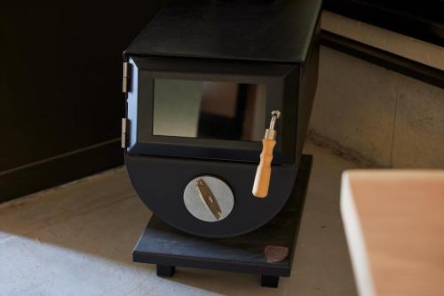 a black watch with a knife inside of it at 民泊のらりくらり in Ajima