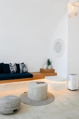 a living room with a couch and a table at Three Bells Suites in Firostefani