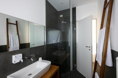 a bathroom with a sink and a glass shower at Solea Relais di Charme- Adults only in Trecastelli