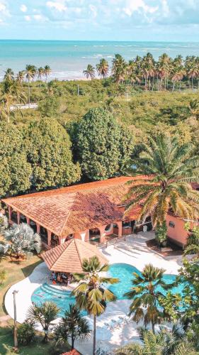 an aerial view of a resort with a swimming pool at Eco Pousada Paraíso dos Coqueirais in Japaratinga