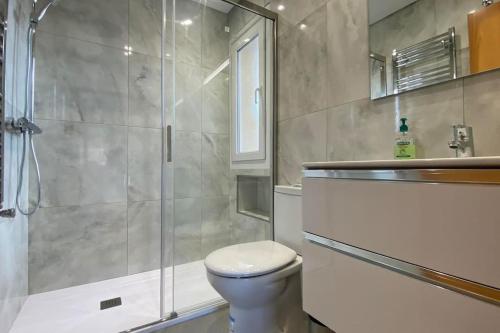 a bathroom with a toilet and a glass shower at Villa Alegre - 2 bed villa with private heated pool on Mar Menor Golf - family friendly in Torre-Pacheco