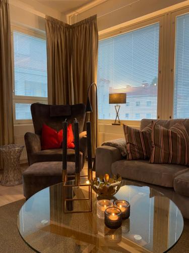 a living room with a couch and a glass table at Apartment Leppä Rovaniemi in Rovaniemi