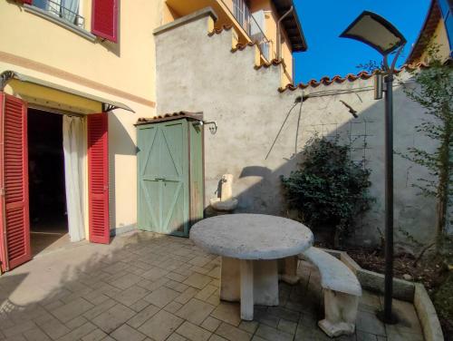 a stone table and bench in front of a building at CASA DI LUCA in Stezzano