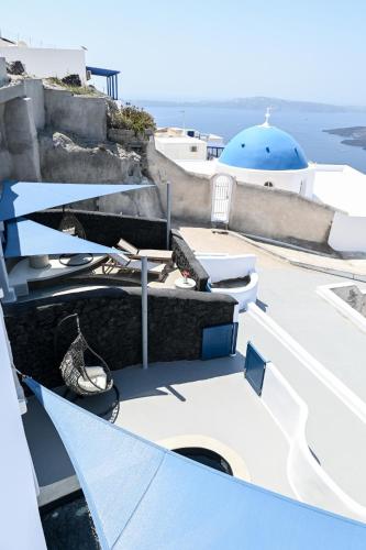 a view from the top of a building with a blue dome at Three Bells Suites in Firostefani