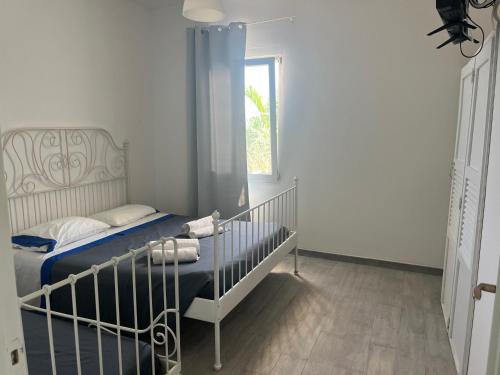 a small bedroom with a bed and a window at Residence Blumarine in Ostuni