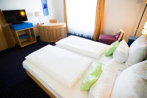 Кровать или кровати в номере ibis Styles Leipzig