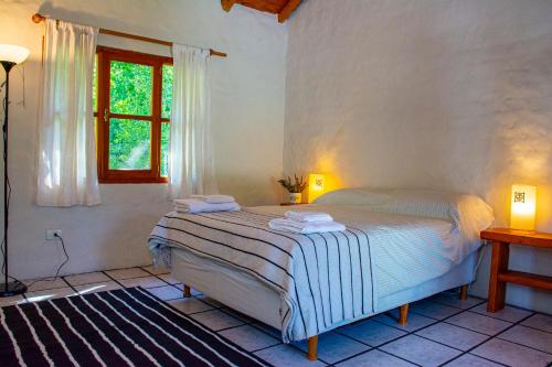 Ein Bett oder Betten in einem Zimmer der Unterkunft Hostería de Montaña Las Pataguas