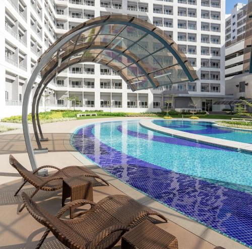 a swimming pool in front of a building at SMDC GRACE RESIDENCIES in Manila