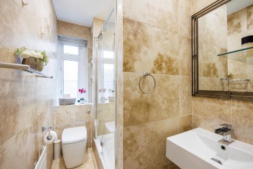 a bathroom with a sink and a shower and a toilet at One Bedroom Near Russell Square in London