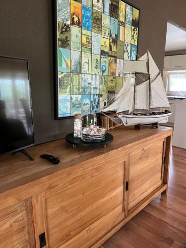 a model of a boat on top of a wooden dresser at WHITE BEACH HOUSE in Breskens