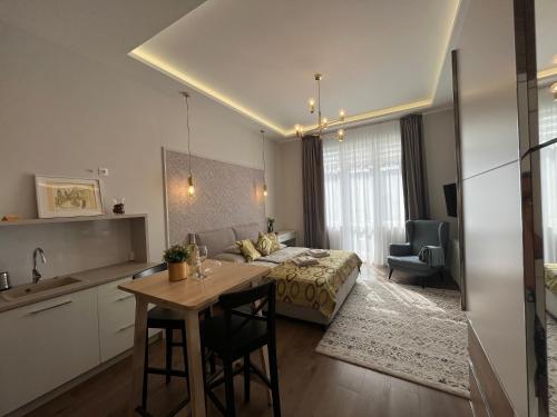 a bedroom with a bed and a table in a room at Visit Debrecen Apartman in Debrecen