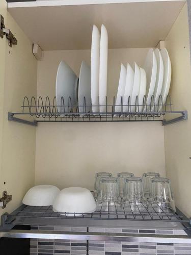 a shelf with plates and glasses on it at Ritiro sul fiume Mantova, Cremona Circuit in Canneto sullʼOglio