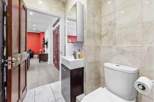 a bathroom with a toilet and a sink at Luxury Flat in London - Mayfair in London