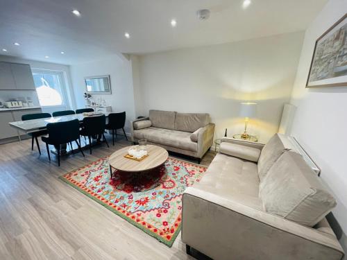 a living room with a couch and a table at Riverside Deluxe Double Room E14 in London