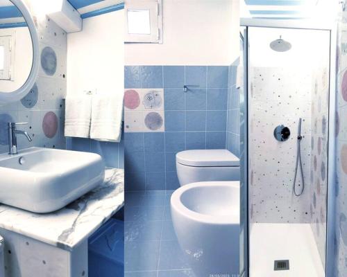 a blue bathroom with a sink and a toilet at Terrazza sul mare attico "Alfeo e Aretusa" in Siracusa