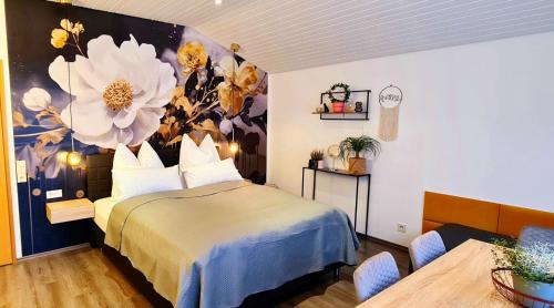 1 dormitorio con 1 cama con un mural de flores en la pared en Ferienwohnungen Krüger ''Apartment Finn", en Michelstadt