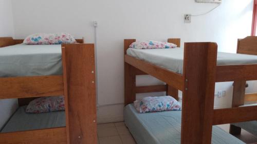 a room with three bunk beds in a room at Hostel Praia de Ondina in Salvador