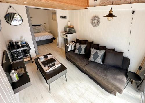 a living room with a couch and a table at 1 Bed Cabin - Sleeps 2 - Pets - Garden - Parking in South Hayling