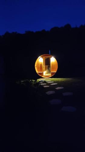 a round house with a light in the dark at Résidence de Suzanne Gîte avec sauna privatif in Brommat