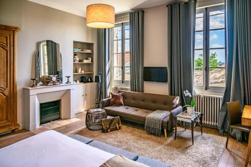 a living room with a couch and a fireplace at Clos 1906 in Saint-Émilion