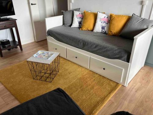 a white couch with pillows on it in a living room at Studio vue sur l’océan in Saint-Brevin-les-Pins