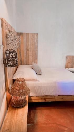 a bedroom with a bed with a basket on it at La Conchita Tulum in Tulum