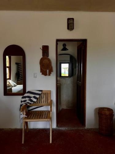 a room with a mirror and a bench and a door at La Conchita Tulum in Tulum