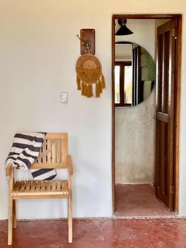 a room with a wooden bench and a mirror at La Conchita Tulum in Tulum
