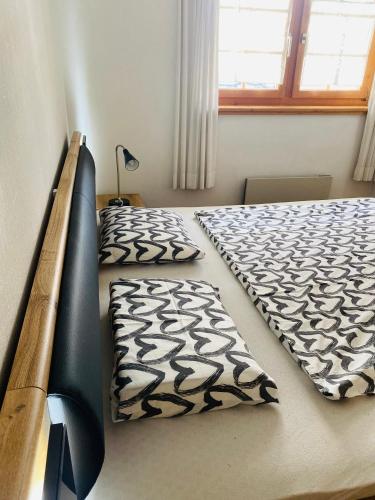 a bedroom with two twin beds and a window at Mountain Getaway Sedrun in Rueras