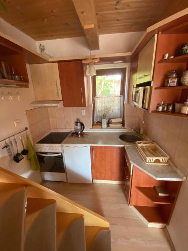 a kitchen with a sink and a stove top oven at Apartmán Donovaly Mišuty 586 in Donovaly