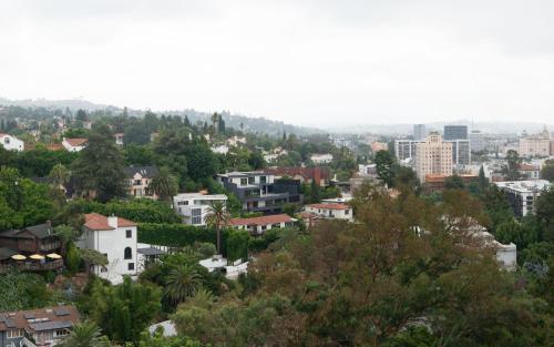 a view of a city with trees and buildings at Hollywood Hills Hotel in Los Angeles