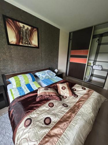 a bedroom with a bed and a large mirror at Levilena apartament Osiedle Bałtyk in Grzybowo