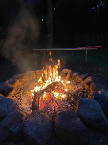 a fire pit with rocks around it at night at Leśnisko in Jerutki