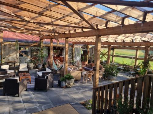 an outdoor patio with a wooden pergola at The Old School House - Gaulverjaskoli in Selfoss