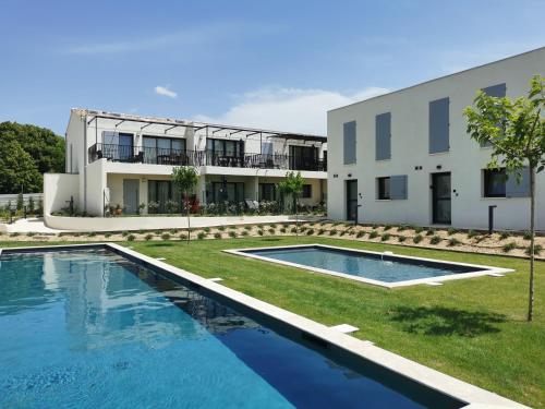 a house with a swimming pool in front of a building at A-Ventoux Malaucène - Au pied du Ventoux in Malaucène