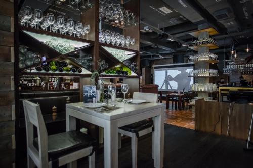a dining room with a white table and wine glasses at AZIMUT Hotel Kemerovo in Kemerovo