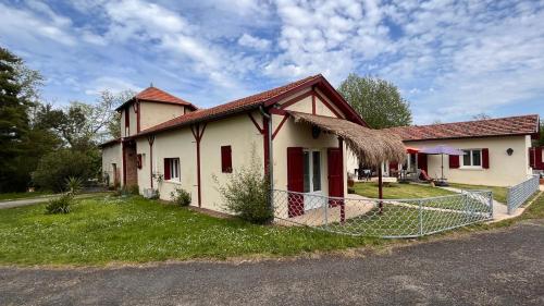 a house with a fence in front of it at Métairie de Moutiques in Cazaubon